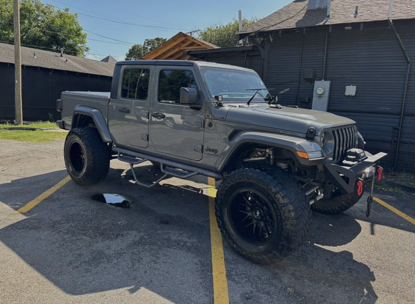 Lifted gray Jeep Gladiator front three-quarter after exterior detail