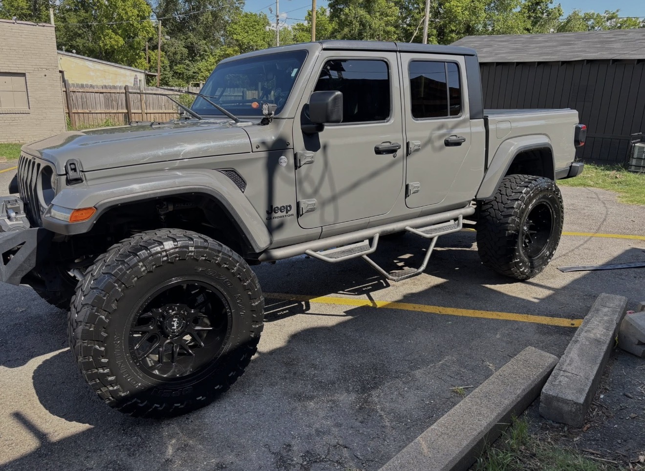 Lifted gray Jeep Gladiator side profile after exterior detail